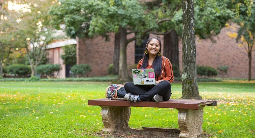 student in middle of campus