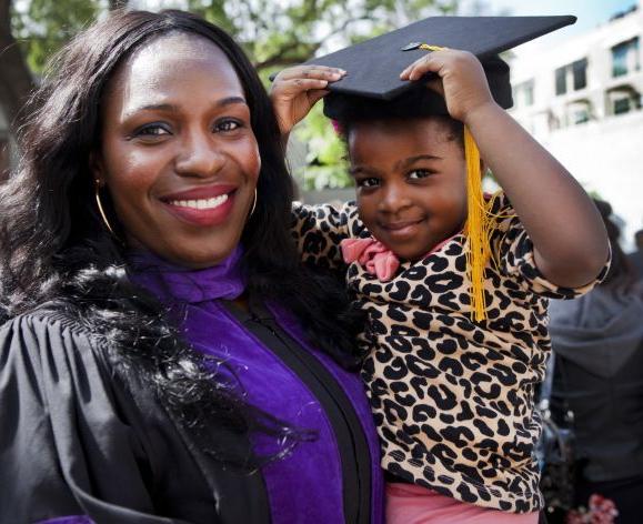 McGeorge graduate holding child