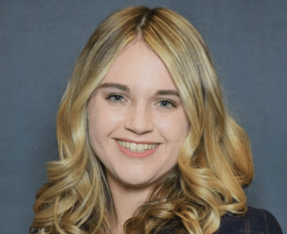 A portrait of a woman wearing a suit